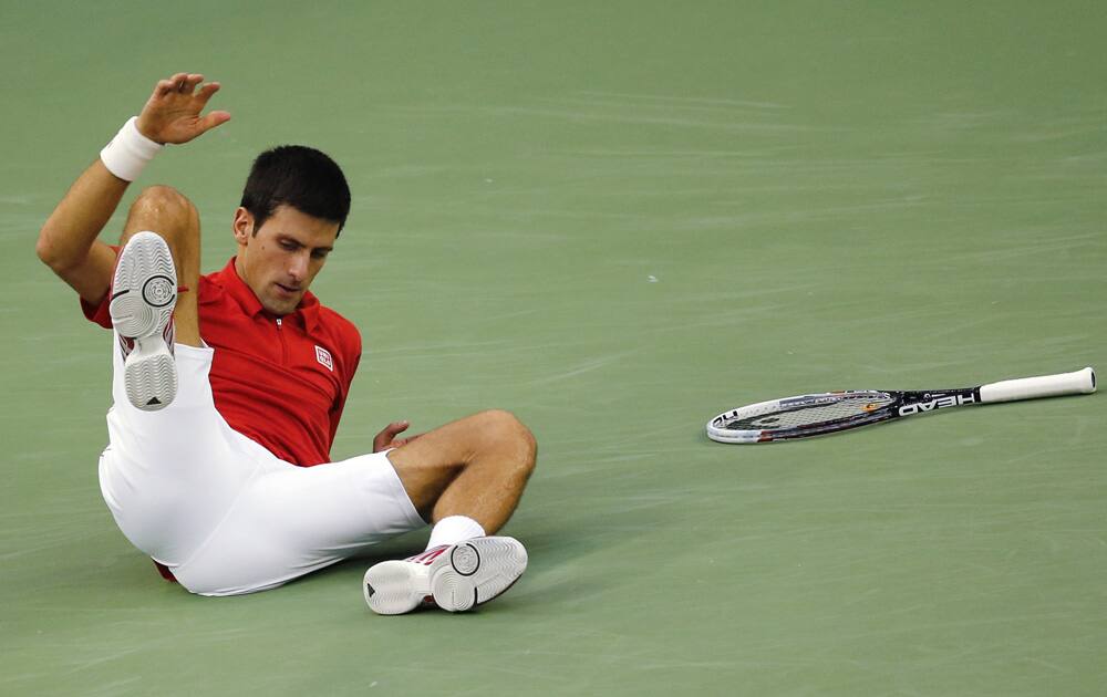 Serbia`s Novak Djokovic slips and falls on the court during the singles semifinal match against France`s Jo-Wilfried Tsonga at the Shanghai Masters tennis tournament at Qizhong Forest Sports City Tennis Center in Shanghai.