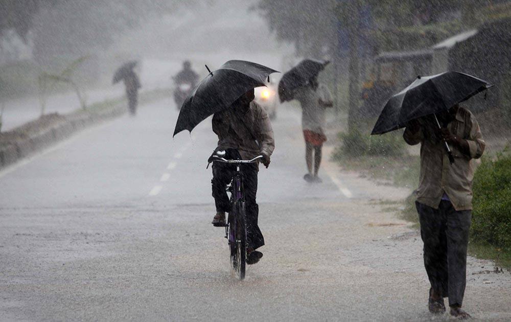 Villagers hold umbrellas as they walk towards a cyclone shelter in their village near Chatrapur in Ganjam district, about 200 kilometers (125 miles) from the eastern Indian city Bhubaneswar.