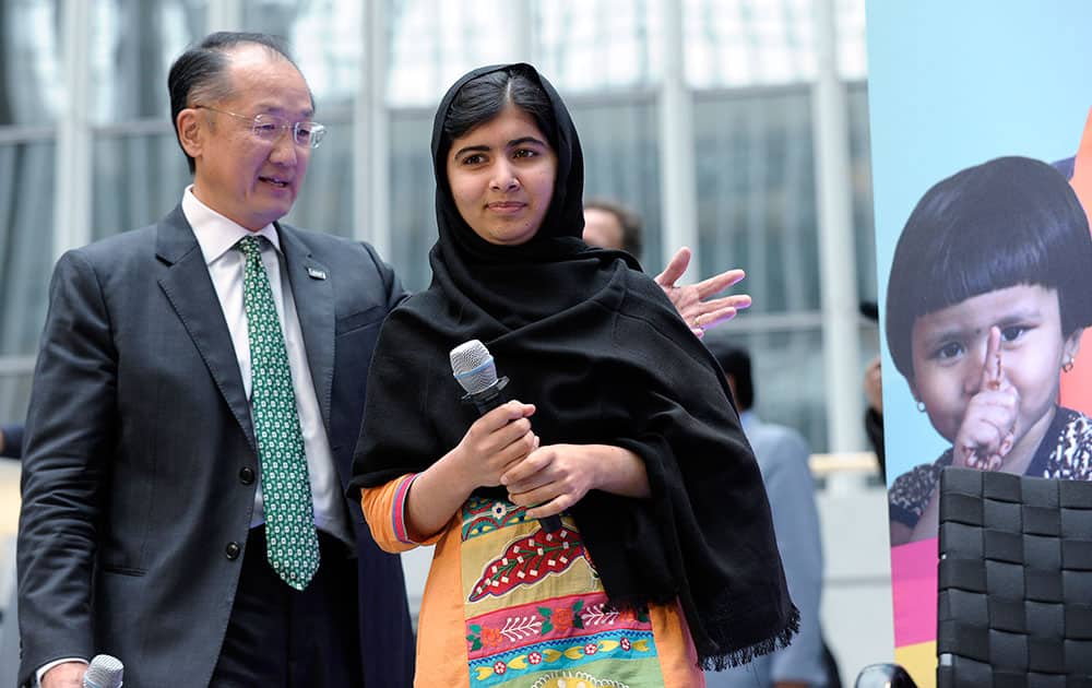 Malala Yousafzai, the 16-year-old girl from Pakistan who was shot by the Taliban, arrives with World Bank President Jim Yong Kim, prior to speaking about her fight for girls` education on the International Day of the Girl at the World Bank in Washington.