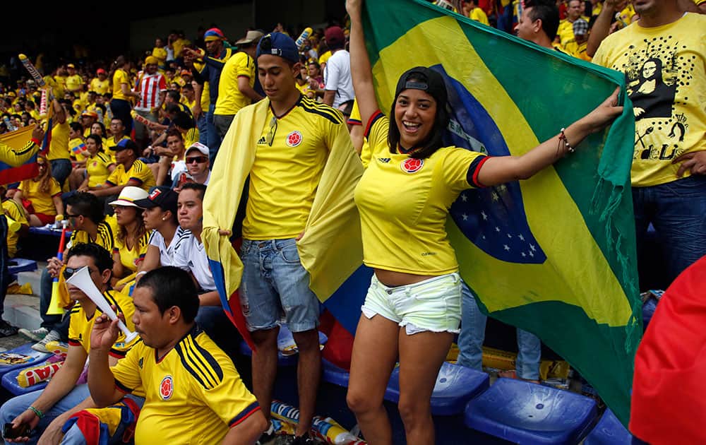 Fans of Colombia`s soccer team cheer before a 2014 World Cup qualifying soccer match against Chile in Barranquilla, Colombia.