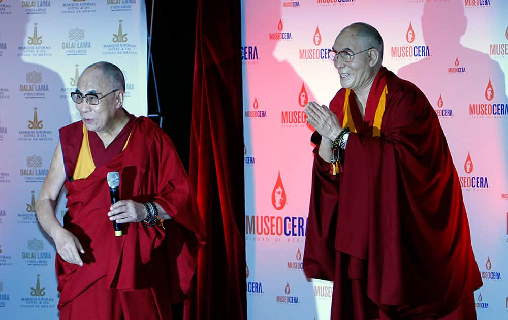The Dalai Lama, left, stands next to a wax figure in his likeness at a press conference in Mexico City.