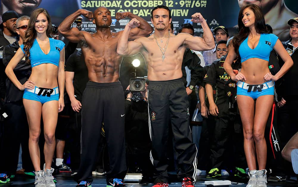 Timothy Bradley and Juan Manuel Marquez pose for photos after the weigh-in for their Saturday WBO welterweight title fight, in Las Vegas.