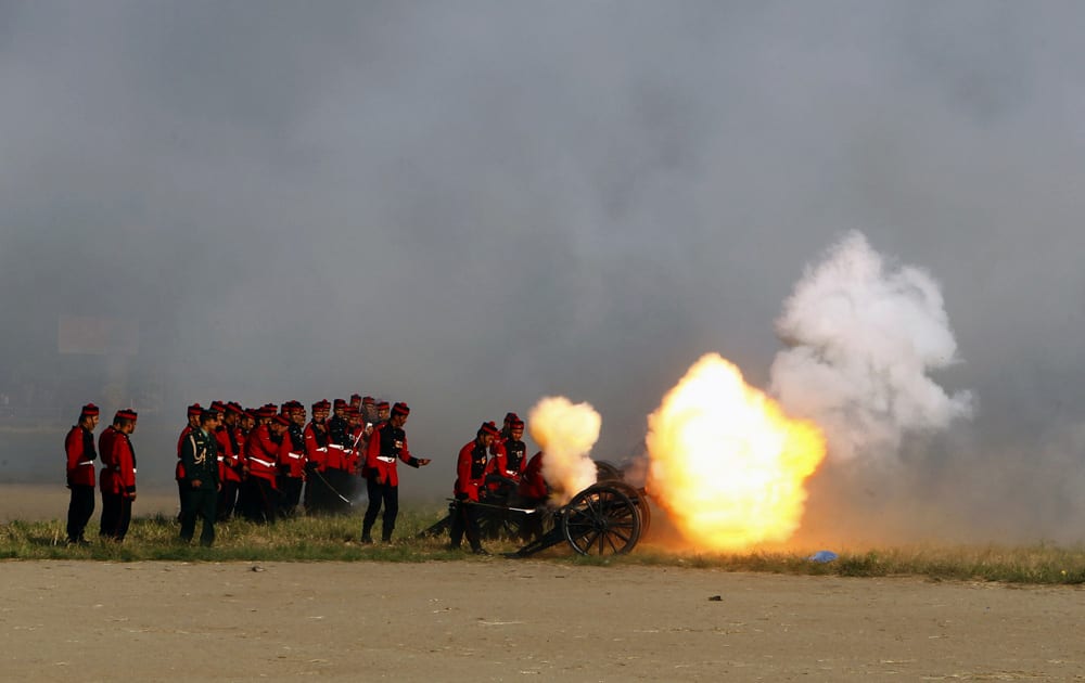Nepalese army soldiers light a cannon on the seventh day of the Hindu festival Dashain in Katmandu, Nepal. The Dashain festival celebrates the victory of good over evil.