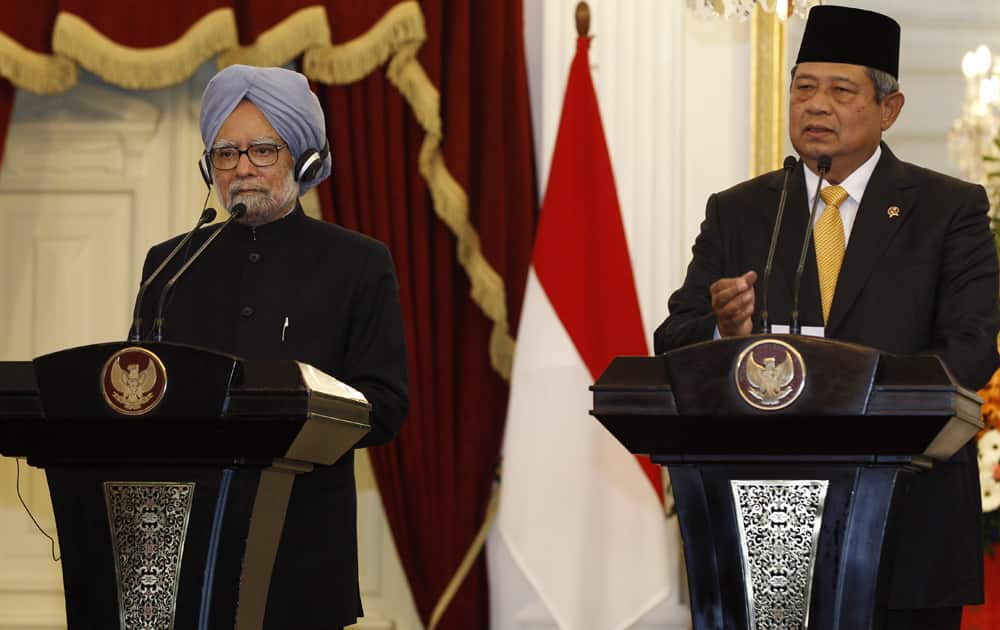 Indian Prime Minister Manmohan Singh listens to Indonesian President Susilo Bambang Yudhoyono speaking during a joint press conference at Merdeka Palace in Jakarta, Indonesia.