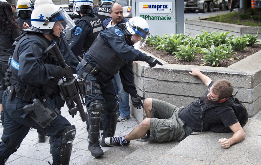 Police disperse protestors during a demonstration near the site of hearings for a pipeline project, in Montreal.