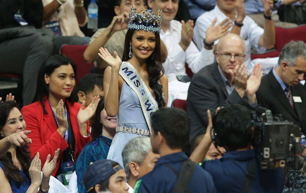 Newly crowned Miss World 2013 Megan Young from the Philippines, waves as she watches a preseason NBA game in Pasay, south of Manila, Philippines.