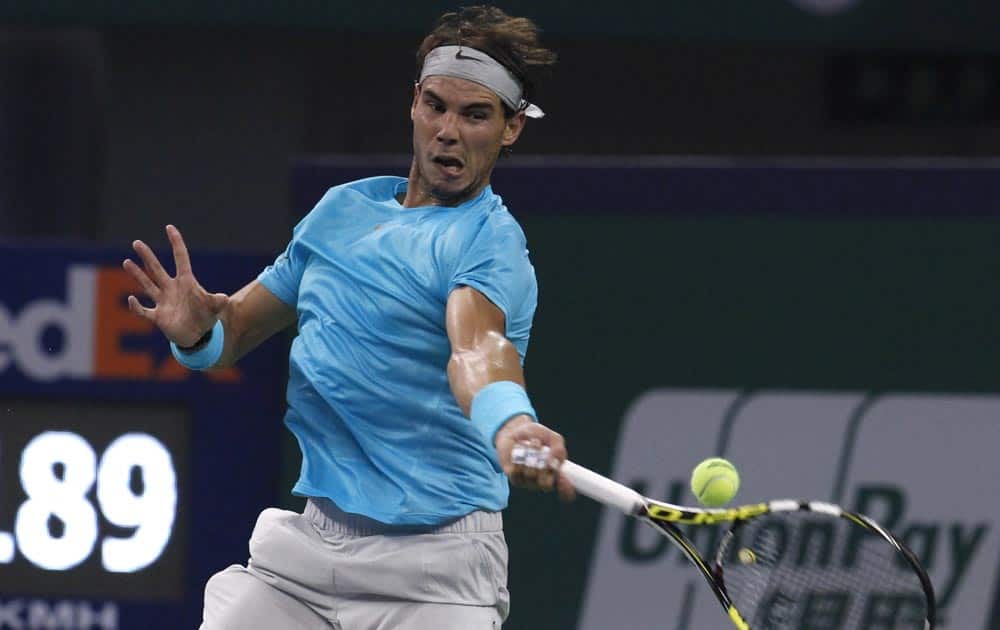 Spain`s Rafael Nadal returns a shot to Argentina`s Carlos Berlocq during a match for the Shanghai Masters tennis tournament at the Qizhong Forest Sports City Tennis Center in Shanghai, China.