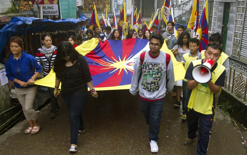 Exiled Tibetans and Indian students protesting against a shooting by Chinese security forces on a Tibetan crowd in Biru county in the Tibet Autonomous Region carry Tibetan flags as they march in Dharmsala.