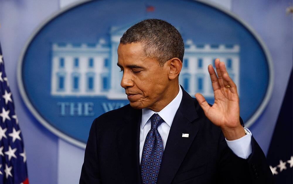 President Barack Obama gestures as he leaves after speaking about the the budget and the partial government shutdown, in the Brady Press Room of the White House in Washington.
