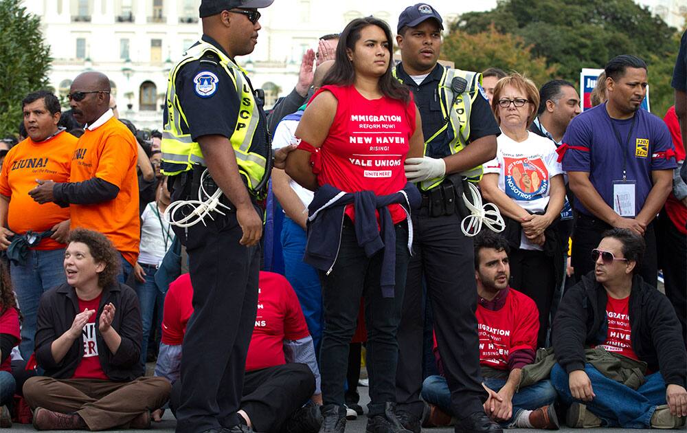 A demonstrator is arrested by U.S. Capitol Police officers on Capitol Hill during a immigration rally in Washington to demand the House Republican leadership pass comprehensive immigration reform with a path to citizenship.