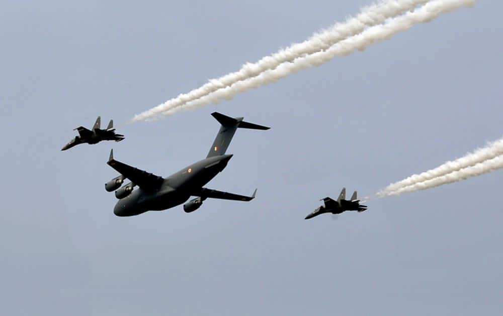 Indian Air Force (IAF) C-17 Globemaster III, center, and SU-30 MKI fly by during Air Force Day at Hindon, on the outskirts of New Delhi.