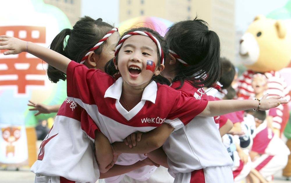 Taiwanese children rehearse for National Day celebrations in front of the Presidential Office in Taipei, Taiwan.