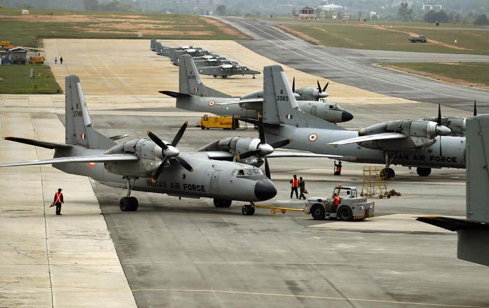 An Indian Air Force (IAF) aircraft is towed as others stand parked in a row on the tarmac of Yelahanka air base ahead of Air Force Day celebrations in Bangalore.