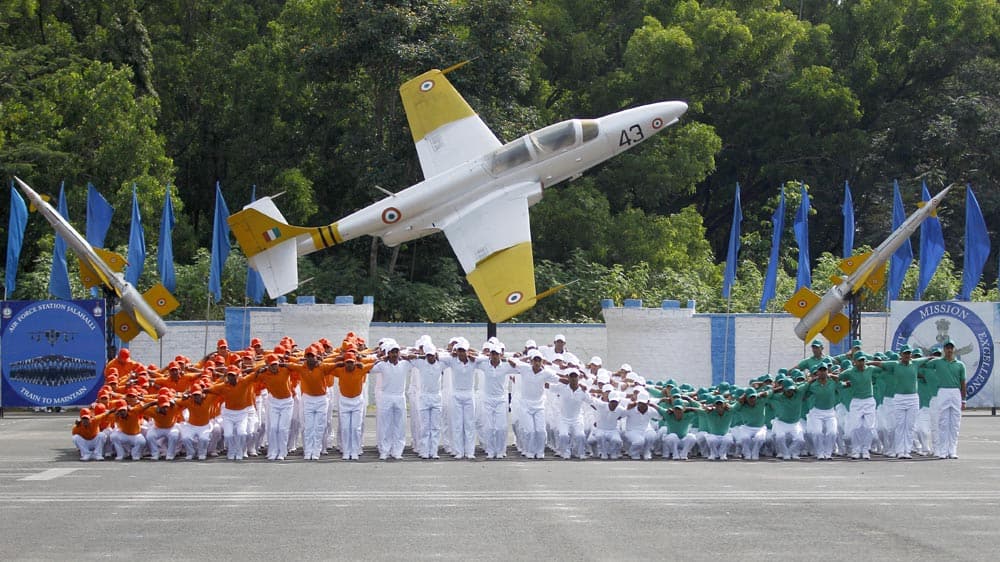 Indian Air Force (IAF) trainees dressed in the Indian tri-colored flag perform during the passing out parade ceremony of their seniors in Bangalore.