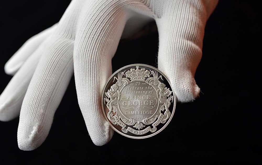 In this photo released by Solent for the British Royal Mint, a 5 pound (with a face value of $8) silver coin produced to commemorate the upcoming christening of Prince George of Cambridge is displayed.