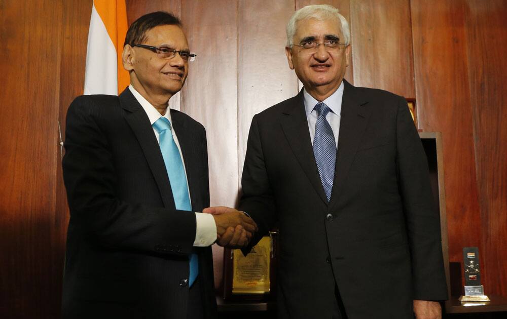 Sri Lankan External Affairs Minister Gamini Lakshman Peiris, shakes hands with his Indian counterpart Salman Khurshid during their meeting in Colombo.