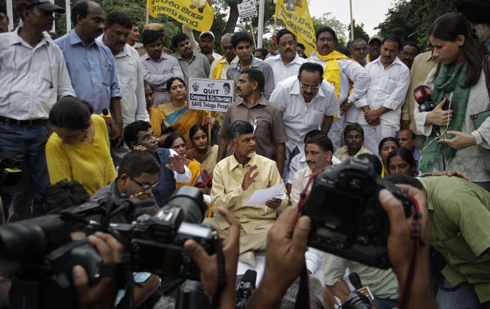 Telugu Desam Party leader Chandrababu Naidu, gestures to supporters during his hunger strike against plans to divide Andhra Pradesh state in New Delhi.