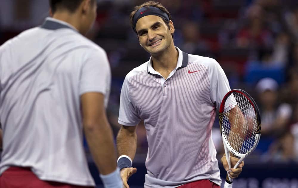 Roger Federer, celebrates a point near his partner Zhang Ze during their doubles match against Kevin Anderson and Dmitry Tursunov at the Shanghai Masters tennis tournament at Qizhong Forest Sports City Tennis Center, in Shanghai.