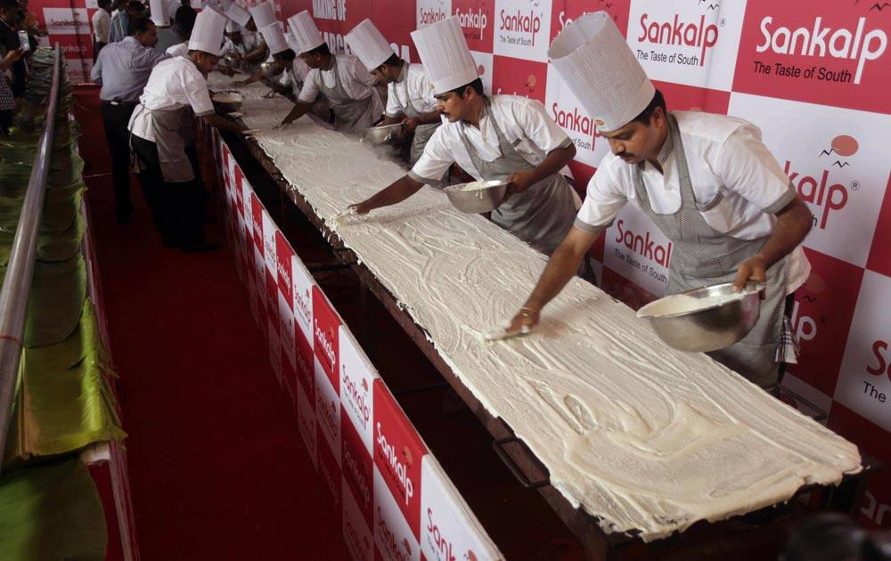 Chefs prepare a 53 feet long Dosa, a south Indian crepe, at a restaurant in Ahmedabad. The restaurant claims to have made the world’s longest dosa in 15 minutes.