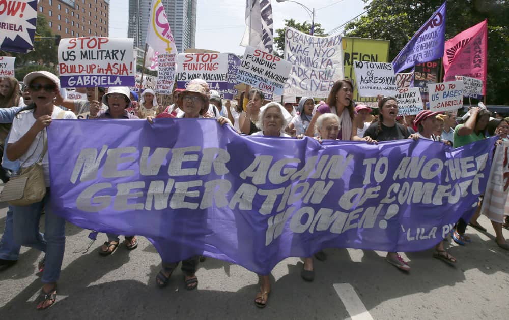 Protesters shout slogans as they march away from the US Embassy in Manila, Philippines, after a rally to protest the forthcoming visit of US State Secretary John Kerry in place of US President Barack Obama who canceled his entire trip to Asia.