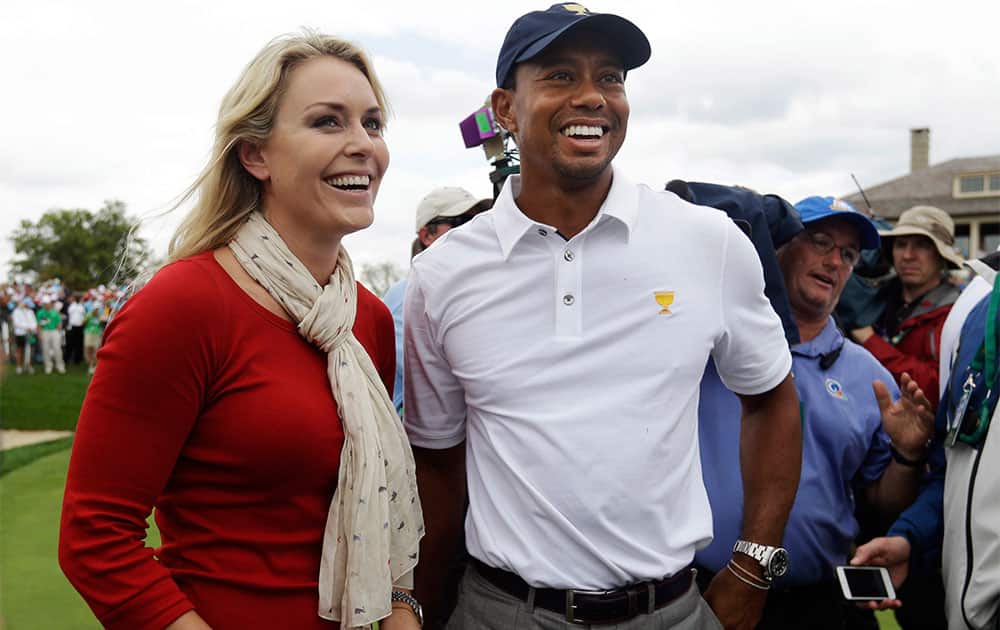 US team player Tiger Woods smiles with girlfriend Lindsey Vonn after US won the Presidents Cup golf tournament at Muirfield Village Golf Club in Dublin, Ohio.