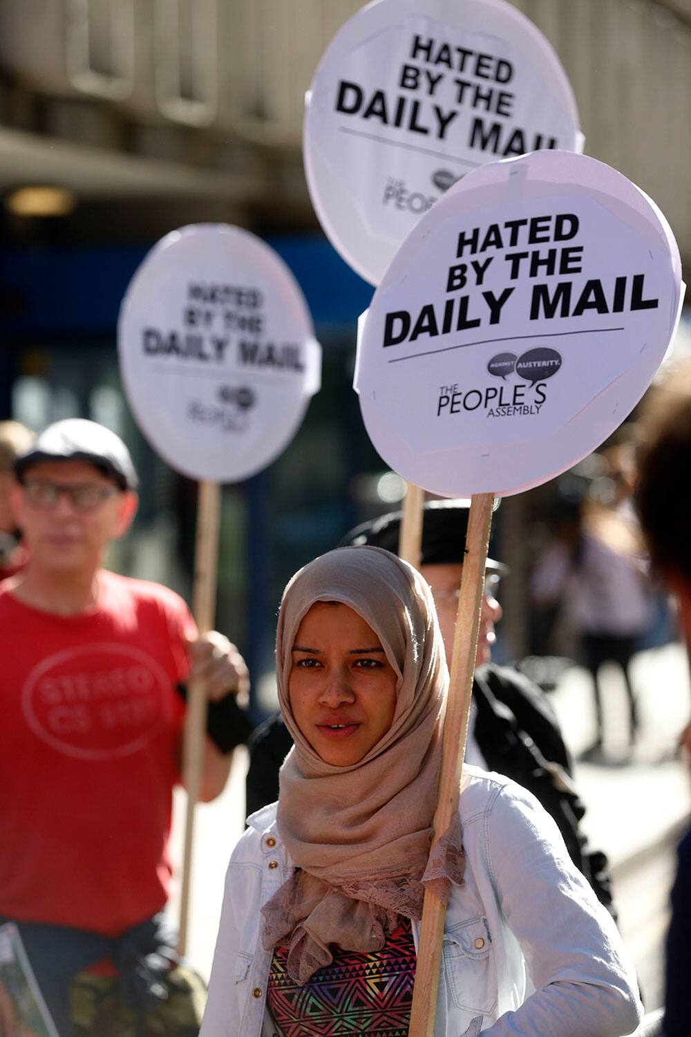 A woman displays a placard, during a `Daily Mail Hates Britain` protest, organised by the People`s Asssembly, outside the Daily Mail newspaper headquarters, in London.