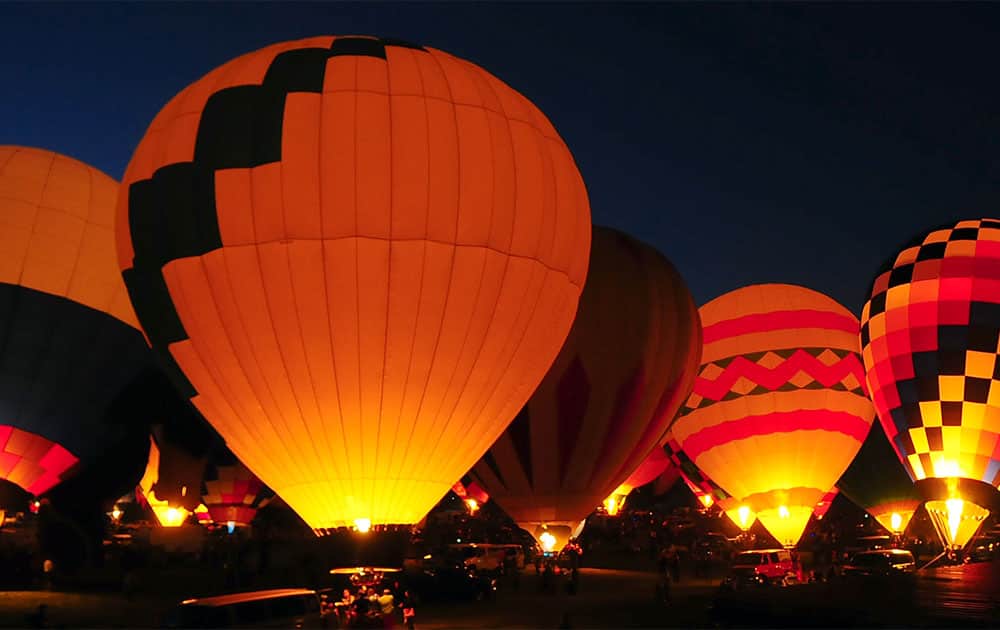 Balloonists fire their burners during Balloon Glow on the second day of the annual Albuquerque balloon fiesta in Albuquerque, N.M.