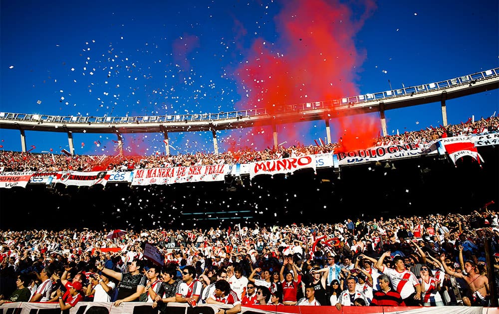 River Plate fans light flares when their team enters the field before an Argentina`s league soccer match against Boca Juniors in Buenos Aires, Argentina.
