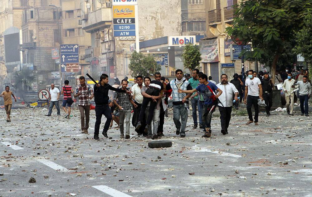 Egyptian security forces and civilians detain a supporter of ousted Egyptian President Mohammed Morsi near Ramsis Square, Cairo, Egypt.
