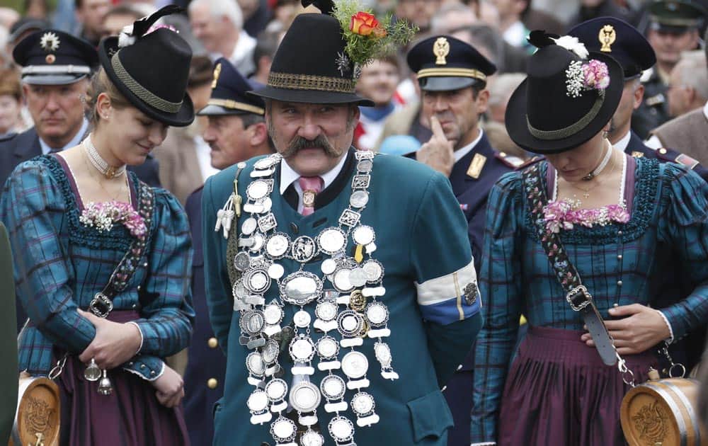 A Bavarian riflemen and women in traditional costumes wait for fireing the muzzle loaders in front of the `Bavaria` statue in Munich, southern Germany.