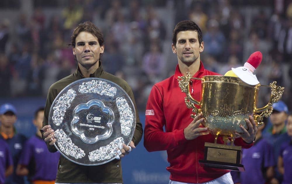 Novak Djokovic of Serbia and Rafael Nadal of Spain pose with their trophies after the final of the China Open tennis tournament at the National Tennis Stadium in Beijing, China.