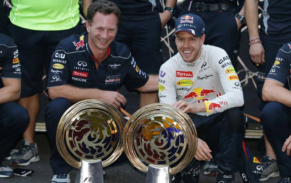 Red Bull driver Sebastian Vettel, right, of Germany and team principle Christian Horner pose for a photo after Vettel`s win in the Korean Formula One Grand Prix at the Korean International Circuit in Yeongam, South Korea.