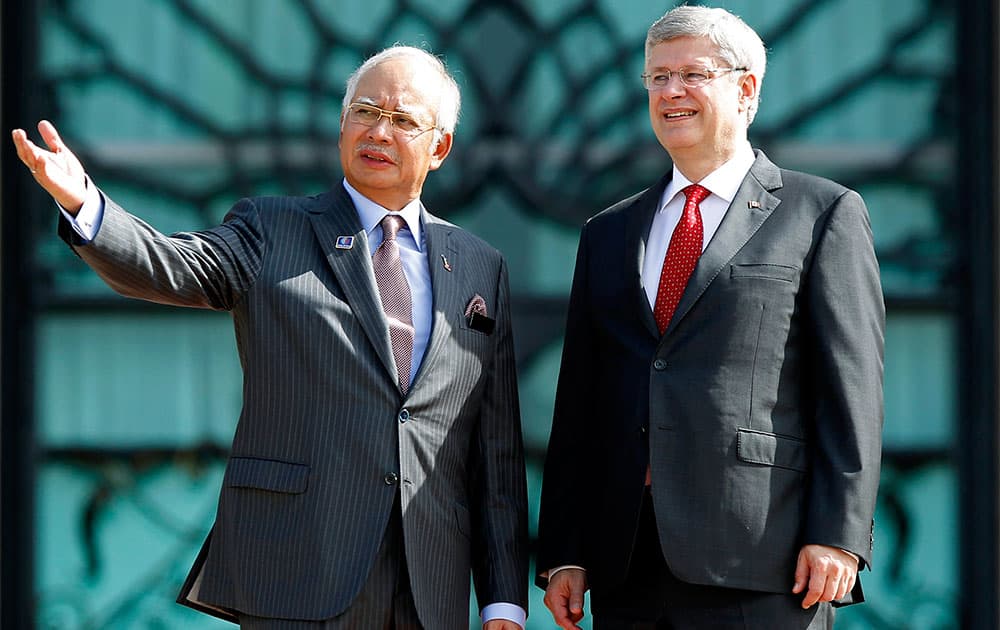 Canadian Prime Minister Stephen Harper listens to his Malaysian counterpart Najib Razak during a welcome ceremony in Putrajaya, Malaysia.