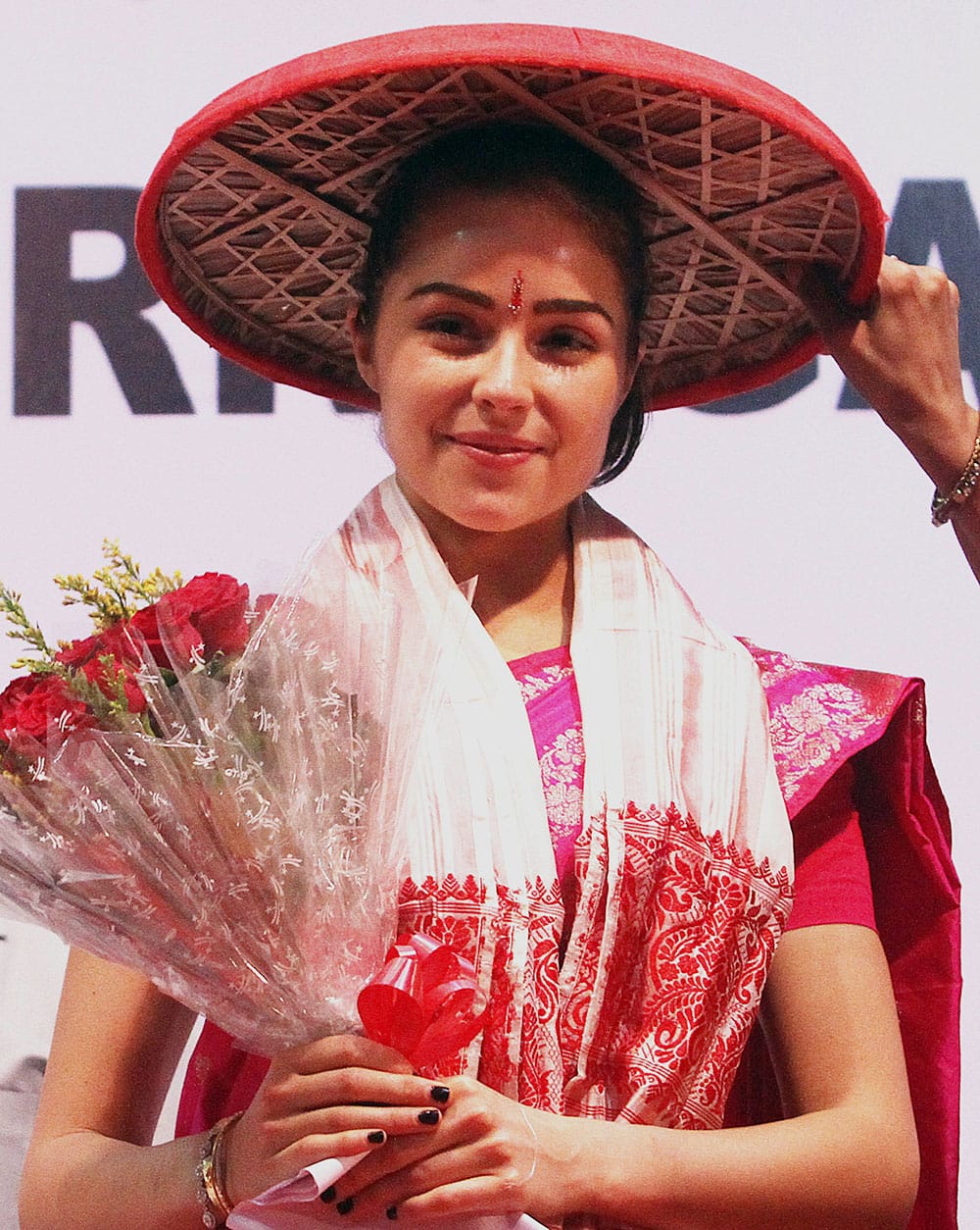 Miss Universe Olivia Culpo wears a traditional Assamese hat called Japi during a campaign