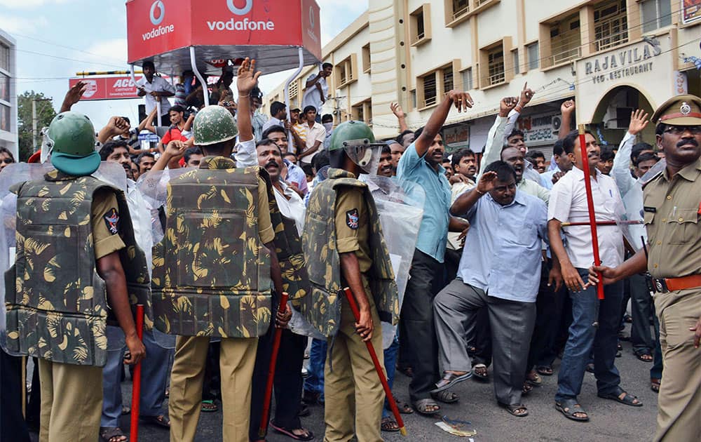 Supporters of a `united` Andhra Pradesh shout slogans as Indian policemen stand guard, during a protest at Karnool district of Andhra Pradesh state, 200 kilometers (124 miles) from Hyderabad.