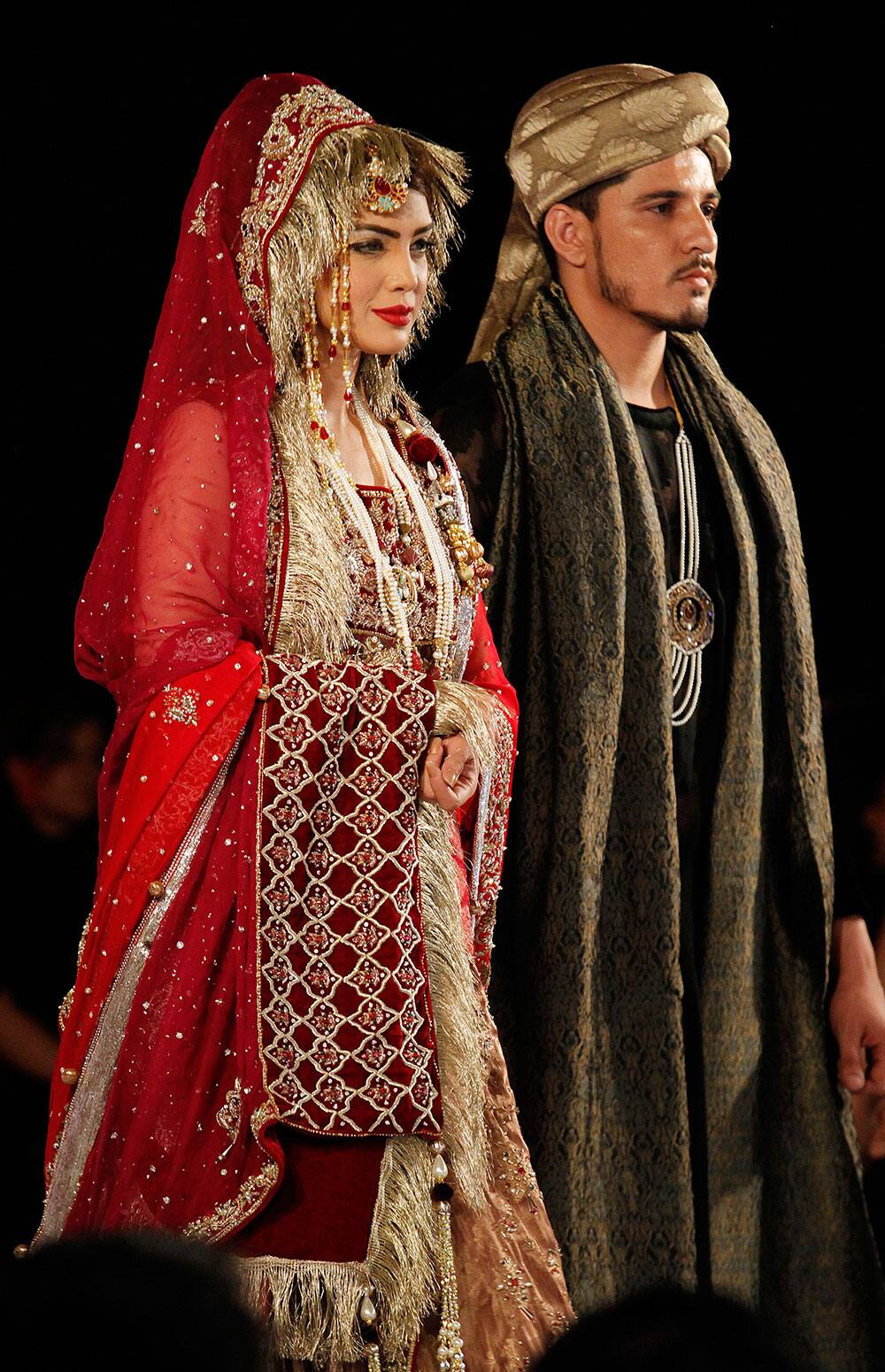 Pakistani models present creation of designer Mohsin Naveed Ranjha during Islamabad Fashion Week.