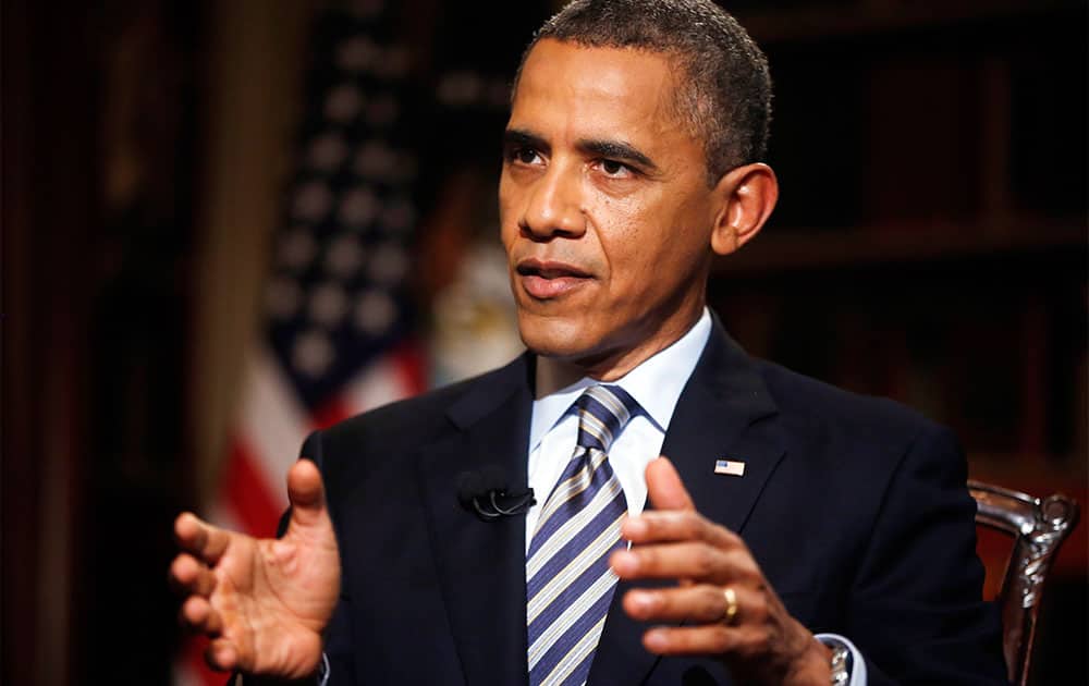 President Barack Obama speaks during an exclusive interview with The Associated Press in the White House library in Washington.