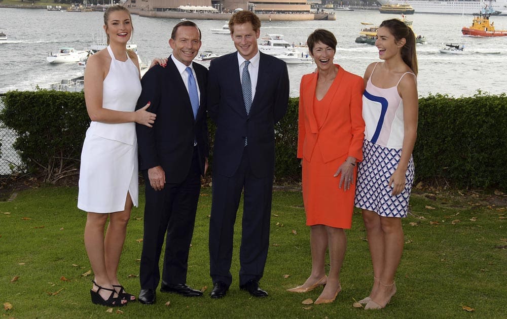 Britain`s Prince Harry, Australia`s PM Tony Abbott, his wife Margie, daughters Bridget and Francis pose for photos, in Sydney.