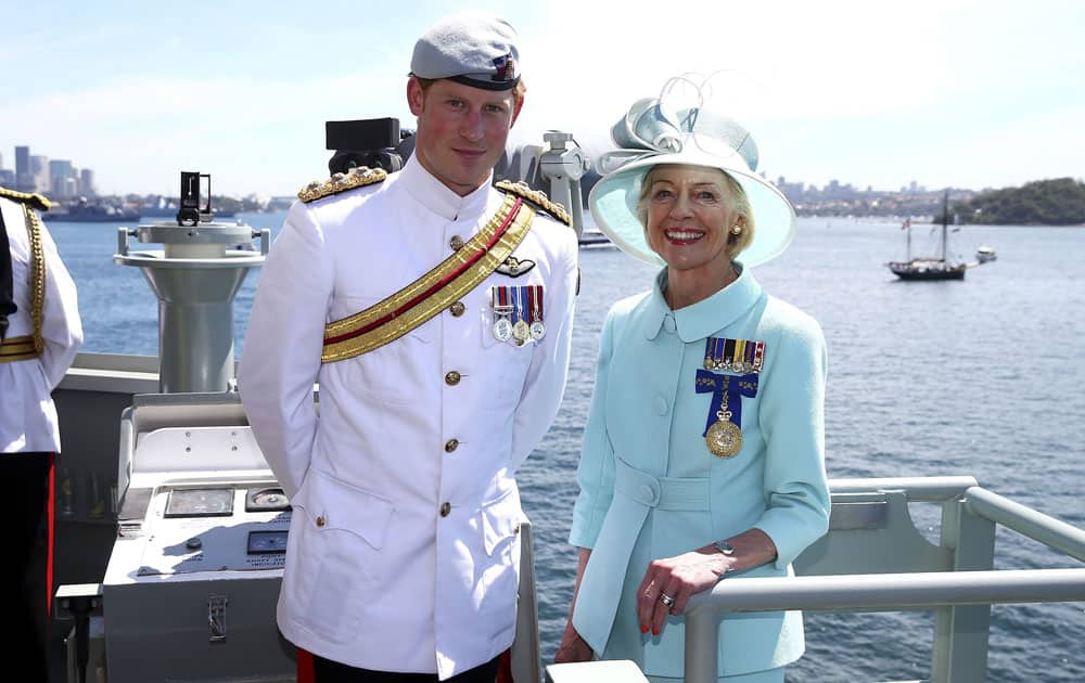 Britain`s Prince Harry and Australia`s Governor-General Quentin Bryce pose for a photo onboard the HMAS Leeuwin as they participate in the 2013 International Fleet Review in Sydney.
