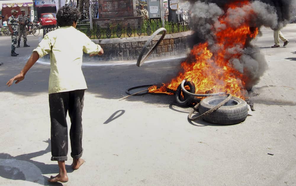 A supporter of United Andhra Pradesh throws a tyre into flames at Tirupati in Chittor district of Andhra Pradesh state 575 kilometers (357 miles) from Hyderabad.