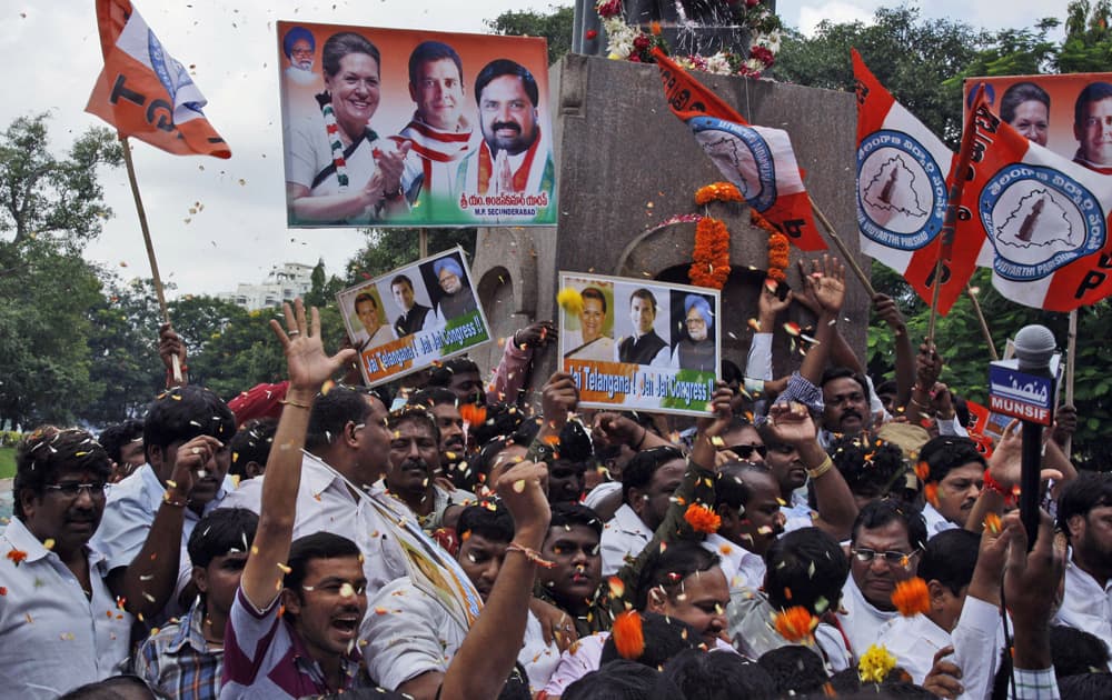 Indian Congress members and supporters celebrate after India`s Union Cabinet approved the creation of a new state “Telangana” in Hyderabad.