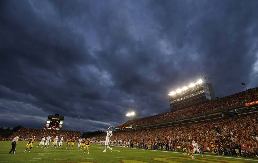 Texas wide receiver Mike Davis, center, drops a pass in the end zone during the first half of an NCAA college football game against Iowa State.