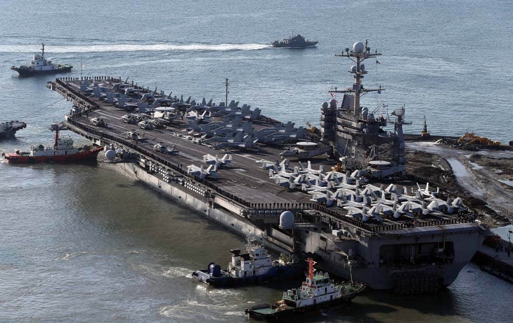 The nuclear-powered aircraft supercarrier USS George Washington is escorted into a navy port in Busan, South Korea.