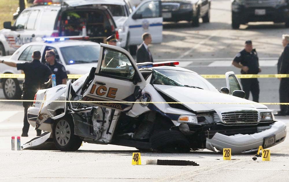 A wrecked Capitol Police car blocks Constitution Avenue NW following a shooting on Capitol Hill in Washington.