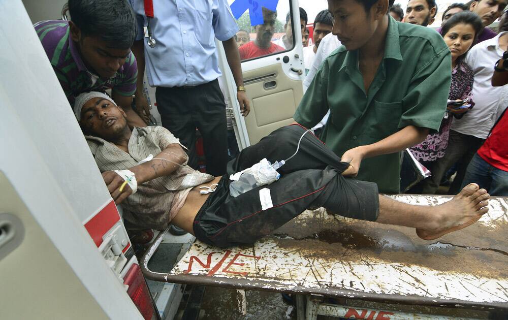 A man injured in a road accident, is brought for treatment at the Guwahati Medical College Hospital. A cargo truck crashed into two minivans packed with laborers headed to work early Thursday in northeast India, killing over two dozen people.