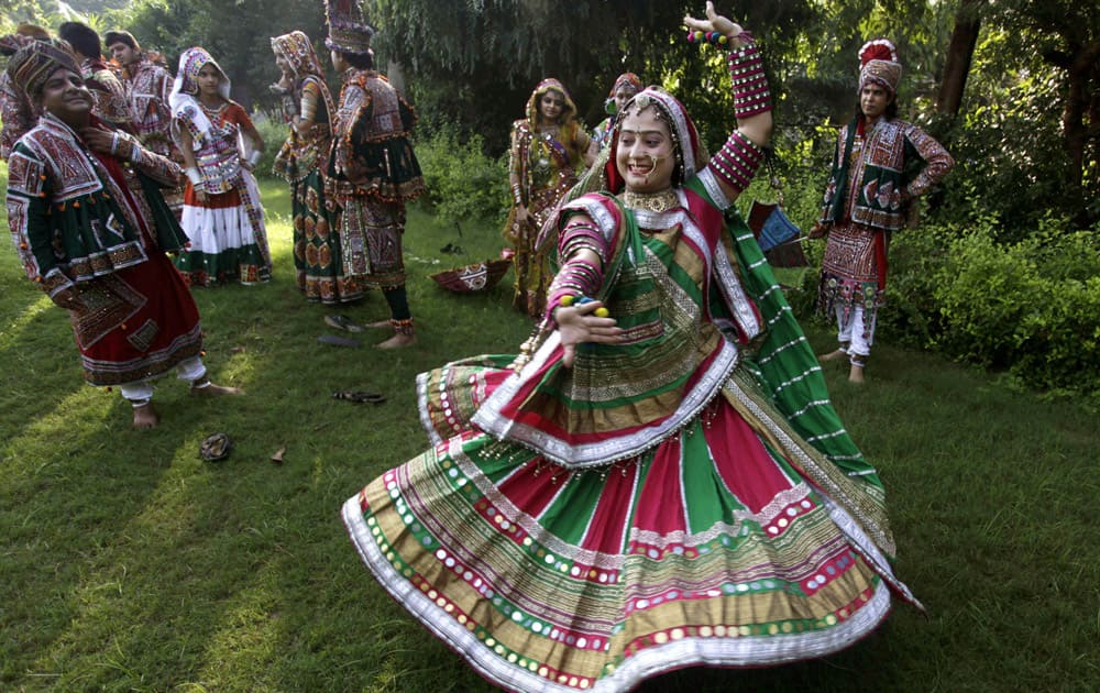 People dressed in traditional attire practice Garba, a form of dance from Gujarat , to celebrate the upcoming festival of Navratri, in Ahmadabad.