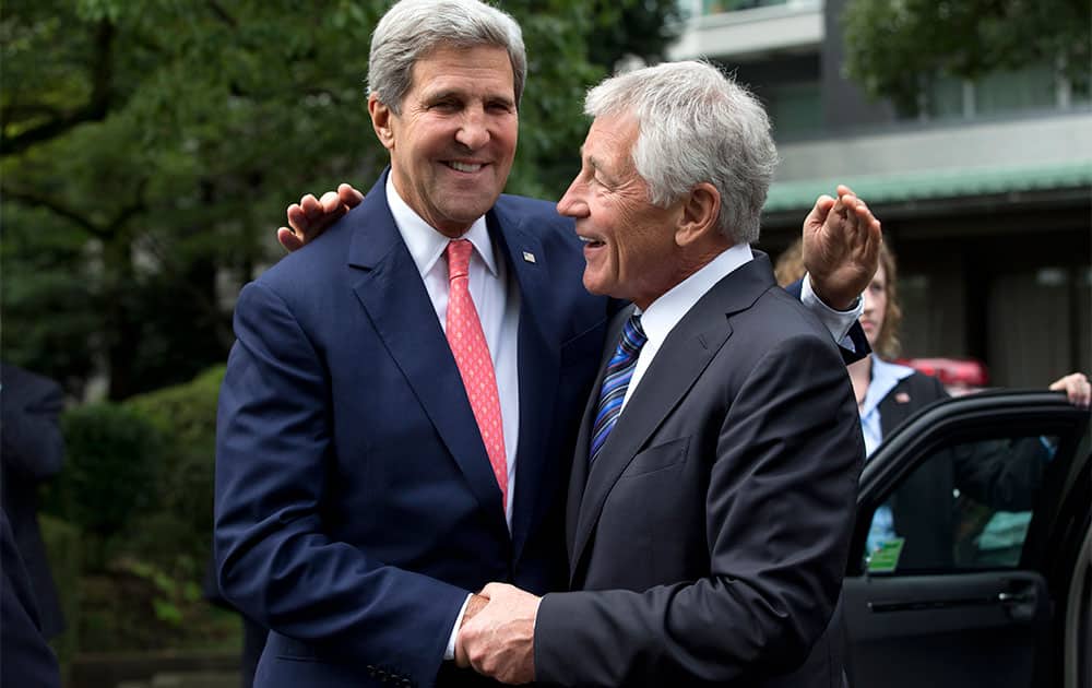 US Secretary of State John Kerry and US Secretary of Defense Chuck Hagel greet each other before attending a wreath laying ceremony at Chidorigafuchi National Cemetery in Tokyo.