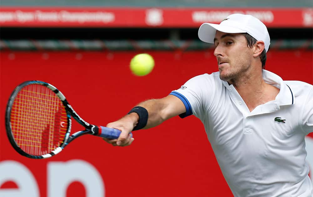 Edouard Roger-Vasselin of France returns a shot against Lukas Lacko of Slovakia during their second round match at the Japan Open Tennis Championships.