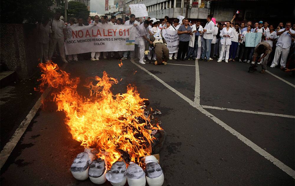 Effigies of politicians burn during a protest by doctors, nurses and medical students outside Congress in Panama City.