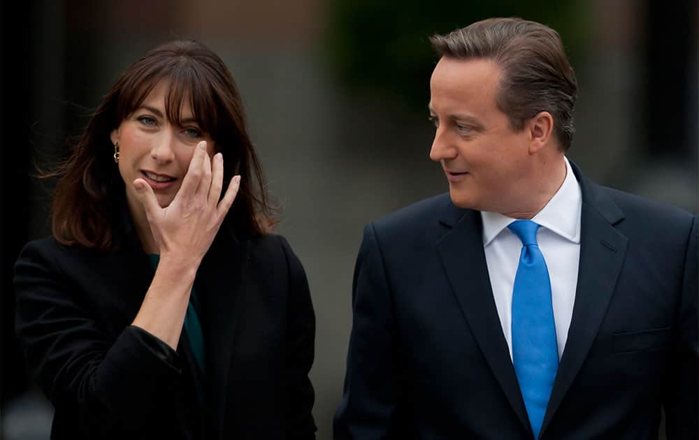 British Prime Minister David Cameron and his wife Samantha walk to the conference hall on the final day of the Conservative Party Conference, Manchester, England.
